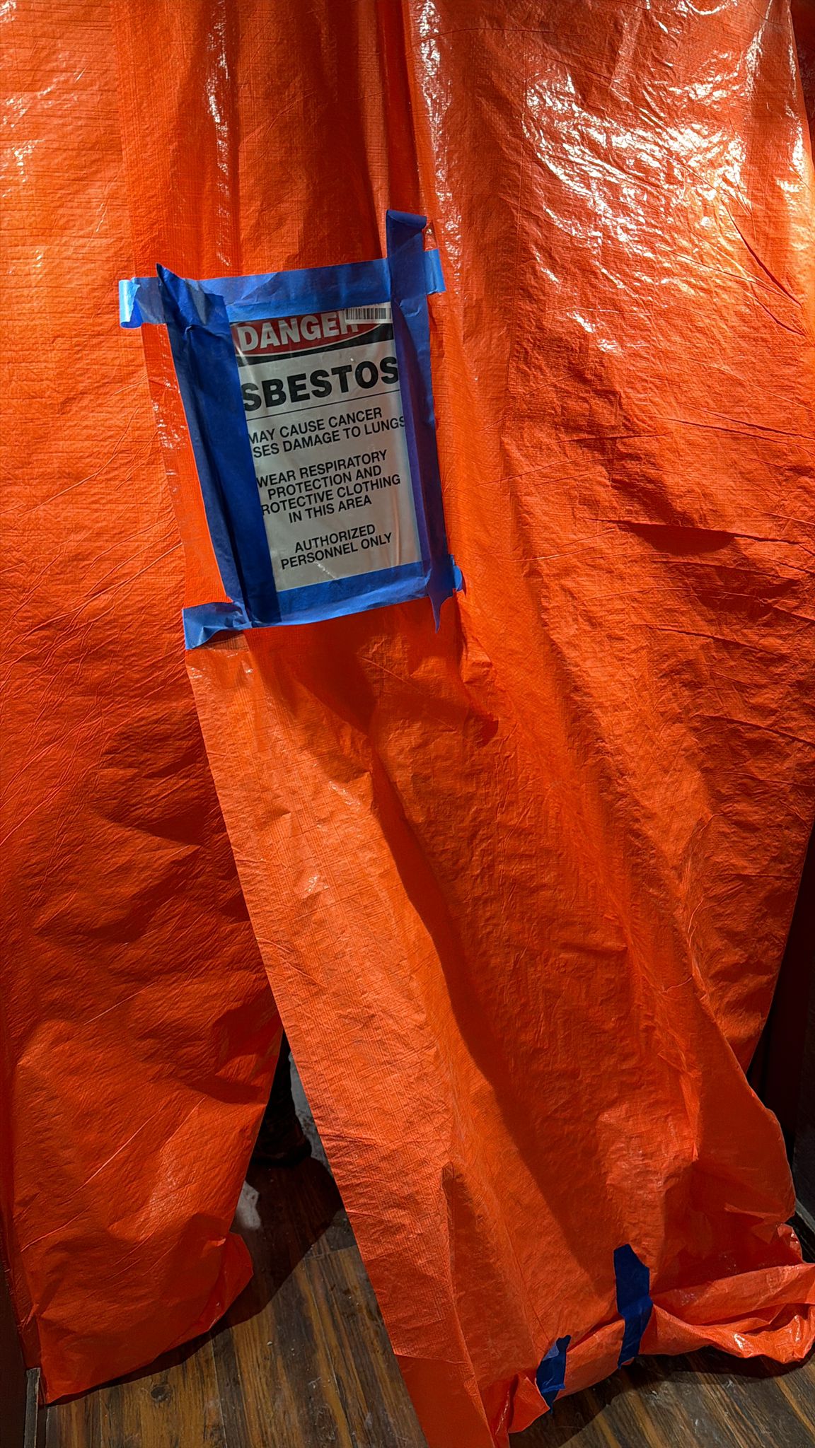 Danger asbestos containment barrier on site